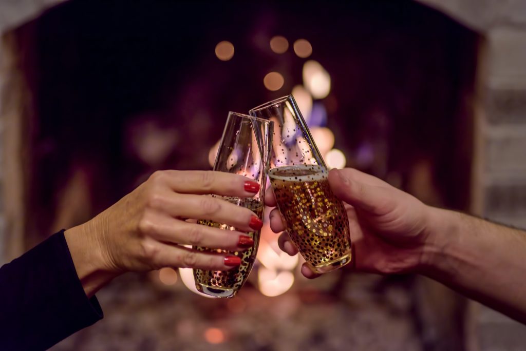 Couple toasts to the new year with a glass of champagne